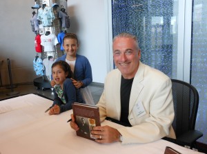 Author Barry Singer, assisted by his daughters, sign his book "Churchill Style"
